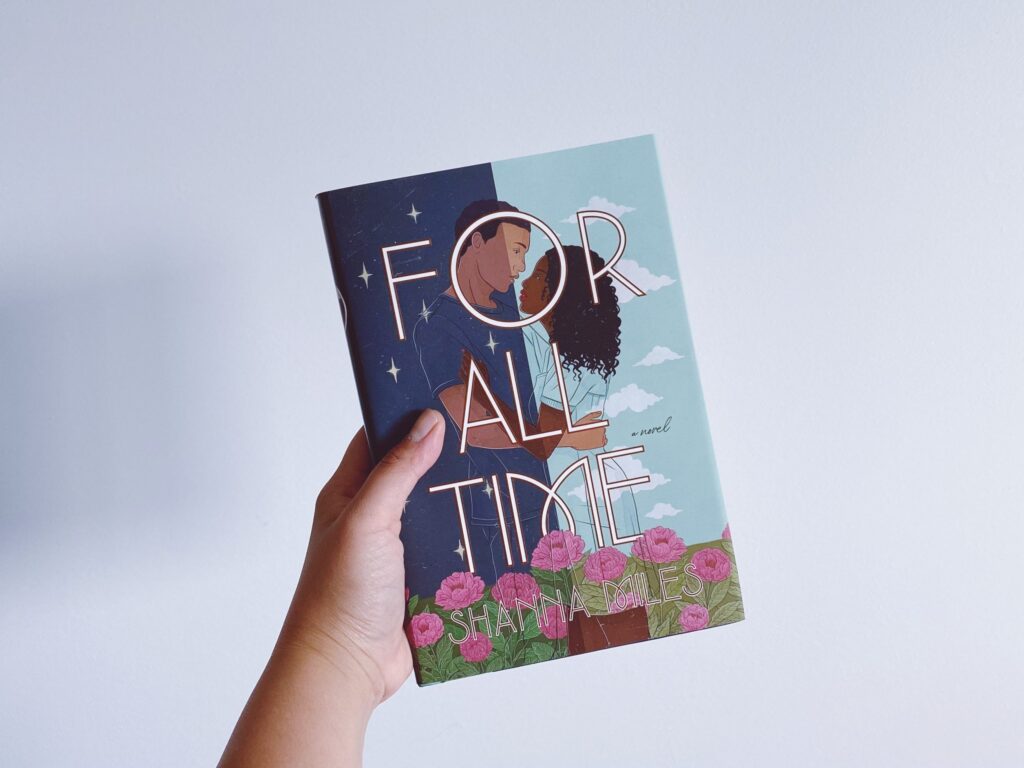 My hand is holding up a hardback copy of For All Time by Shanna Miles against a white background.