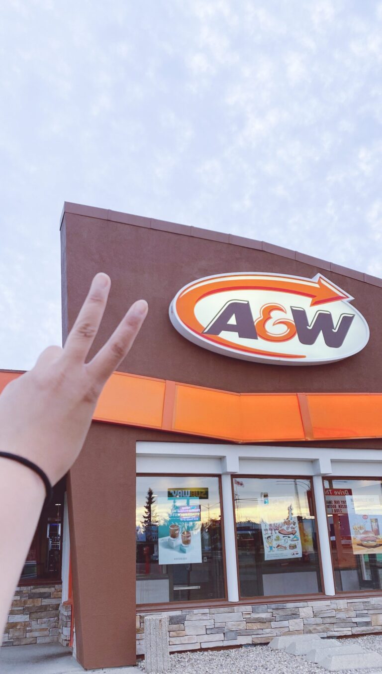 Me making a peace sign in front of and A&W restaurant.